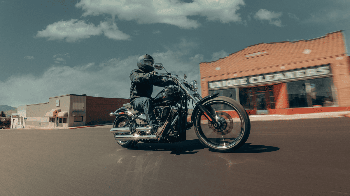 2025 Harley-Davidson® Breakout® cruising past local shops near Deer Park, TX, showing off its stretched styling and chrome details.