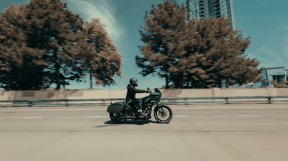 2025 Harley-Davidson® Low Rider® ST in motion on city highway near Deer Park, TX—ideal for new riders seeking confidence and style.