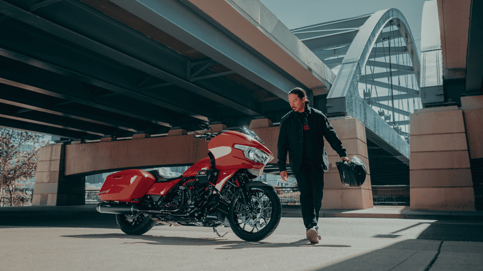 2025 Harley-Davidson® CVO™ Road Glide® ST with two-up riders navigating sharp curve near Deer Park, TX, showcasing confident control and rider comfort.