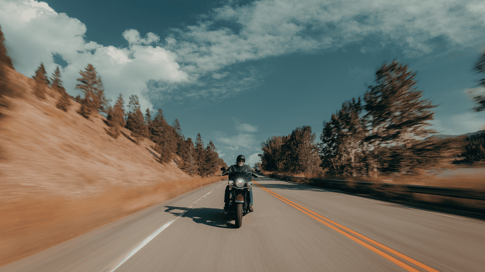 A rider enjoys scenic fall roads near Deer Park, TX, on a 2025 Harley-Davidson® Heritage Classic, powered by its Milwaukee-Eight® 114 engine.