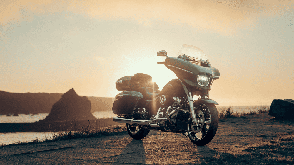 2025 Harley-Davidson® Street Glide® at sunset with LED headlamp glowing, highlighting enhanced visibility for night rides near Friendswood.