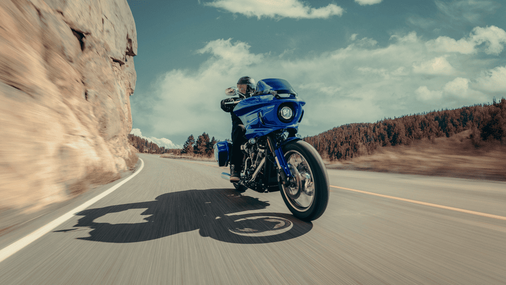 2025 Harley-Davidson® Low Rider® ST leaning into a mountain curve near Friendswood, TX—ideal for new riders seeking performance and control.