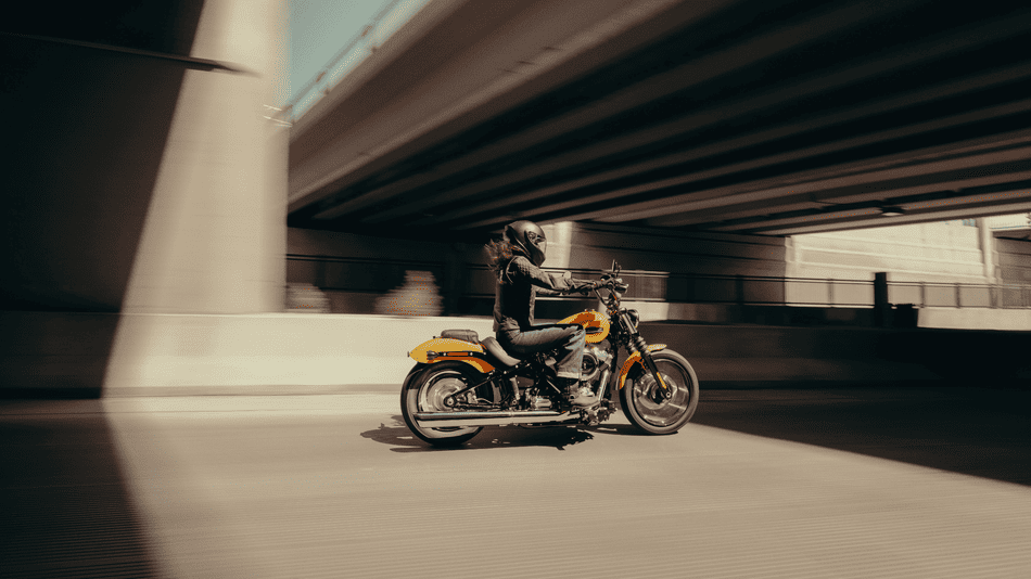 2025 Harley-Davidson® Street Bob® cruising under highway bridge near Deer Park, TX—perfect for weekend adventures and urban rides.
